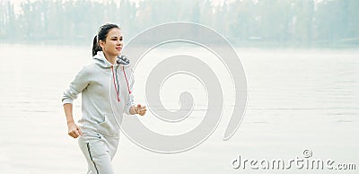 Young woman jogging outside in the park. Runners training outdoors Stock Photo