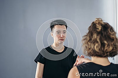 Young woman karate student with her trainer in gym. Taekwondo coach teaching adult woman in personal training. Two women Stock Photo