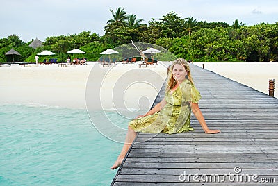 Young woman landing stage on beach on Maldives Stock Photo