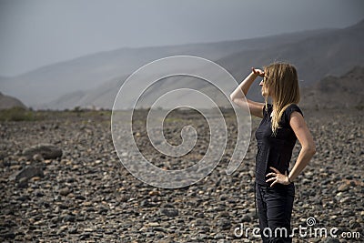 Young woman in the landscape of Hajjar Mountains in Oman Stock Photo