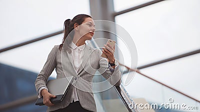 Young woman with a laptop in her hands in a business center, a modern bright office. Career and work Stock Photo