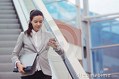 Young woman with a laptop in her hands in a business center, a modern bright office. Career and work Stock Photo