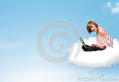 Young woman with laptop sitting on cloud with copy space Stock Photo