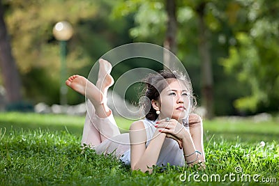 Young woman laying on grass Stock Photo