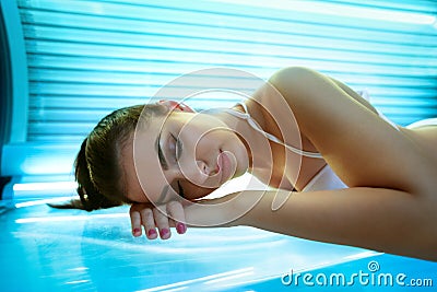 Young woman laying on solarium bed Stock Photo