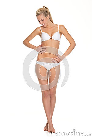 Young woman in lingerie checking body condition Stock Photo