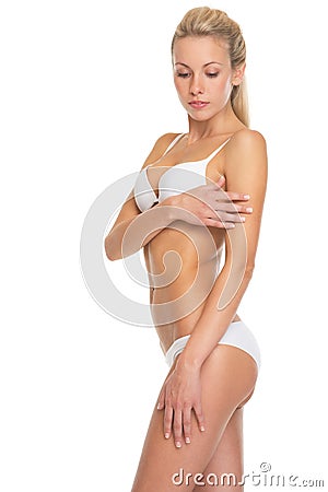 Young woman in lingerie checking skin condition Stock Photo