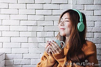 Young Woman Listening Music From Headphone in Cozy House, Closed Eyes and Relaxing Stock Photo