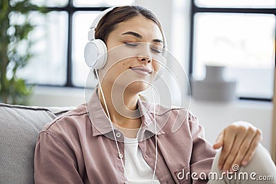 Young woman is listening to music Stock Photo