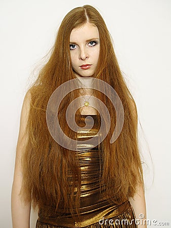 Young woman with long red hair in dress Stock Photo