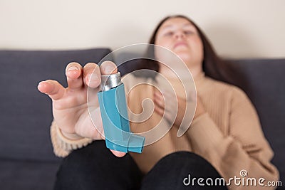 Young woman looking for an asthma inhaler during strong asthma attack, cannot breathing, healthcare concept Stock Photo