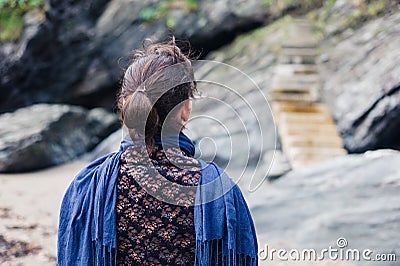 Young woman looking at steps on coast Stock Photo
