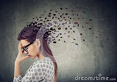 Young woman losing parts of head as symbol of decreased mind function. Stock Photo