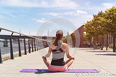 Young woman in lotus position doing yoga . Stock Photo