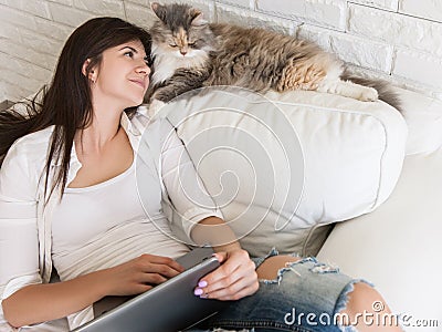 Young woman lovely looks at her cat Stock Photo
