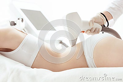 Young woman lying and receiving laser skin care on back Stock Photo