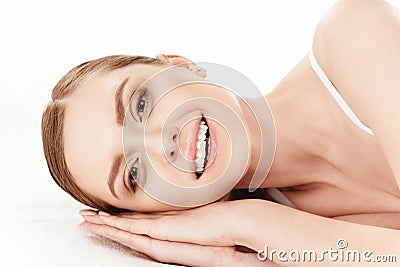 Young woman lying and smiling at camera, skin care concept Stock Photo