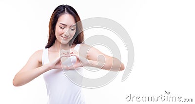 Young woman make heart sign by hands put on heart Beautiful asian female give love with happy expression stand over isolated on Stock Photo