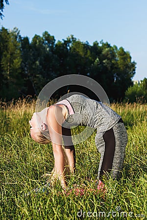 Young woman makes sport exercise Stock Photo