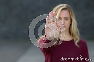 Young woman making a halt gesture Stock Photo