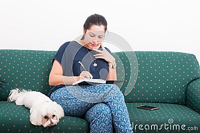 Young woman making notes in her journal Stock Photo