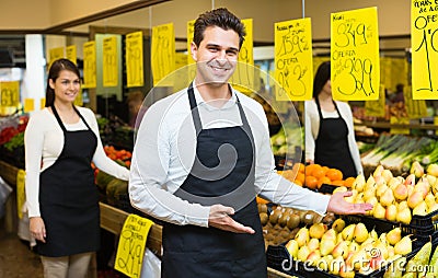 Young woman and man selling fresh grocery Stock Photo