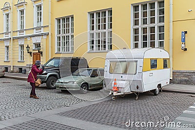 Young woman in mask and man crosses the road. Empty streets in the centre of the city on 1st day of self isolation Stock Photo