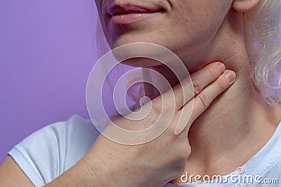 A young woman measures the pulse on her neck Stock Photo