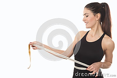 Young woman measuring waist with tape measure Stock Photo