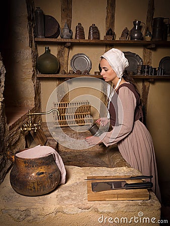 Woman in antique kitchen Stock Photo