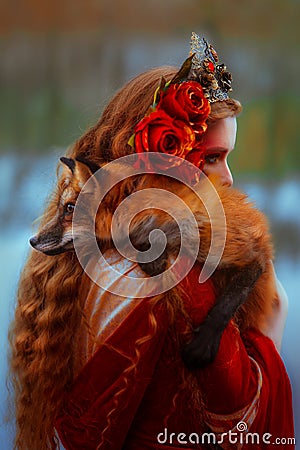 Woman in medieval clothes with a fox Stock Photo