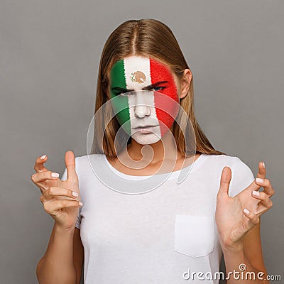 Young woman with Mexica flag painted on her face Stock Photo