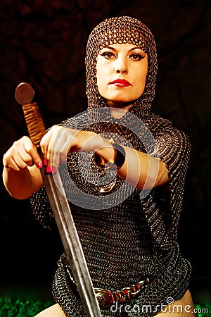 Young woman model in viking armor with sword Stock Photo