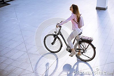 Young woman with modern city electric e-bike clean sustainable urban transportation Stock Photo