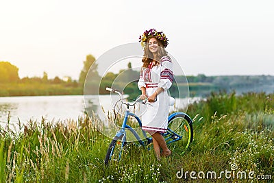 Young woman in national ukrainian folk costume with bicycle Stock Photo