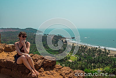 Young woman in North Goa, India. Top view of Vagator Beach Editorial Stock Photo