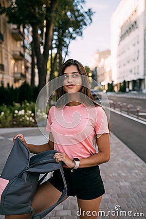 Young woman with open backpack on the street Stock Photo