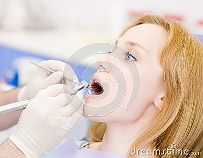 Young woman with open mouth during drilling treatm Stock Photo