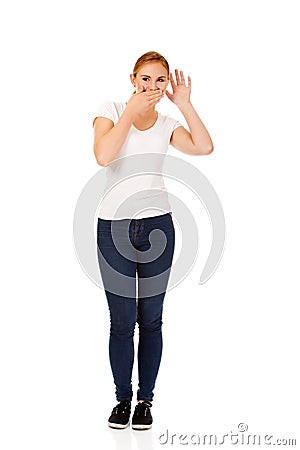 Young woman overhears conversation and giggles Stock Photo