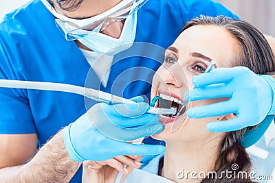Young woman during painless oral treatment in a modern dental office Stock Photo