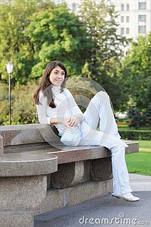 Young woman in a park looking sideway Stock Photo