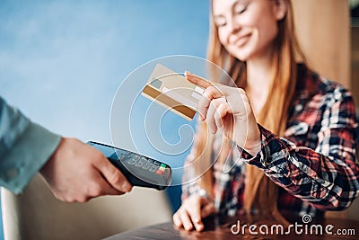 Young woman paying with credit card in cafe Stock Photo