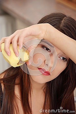 Young woman peeling potato Stock Photo