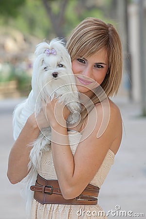 Young woman with pet Maltese dog Stock Photo