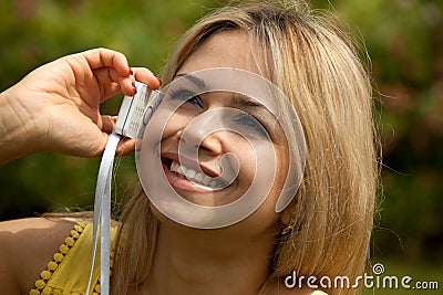 Young woman on phone representative smiling Stock Photo