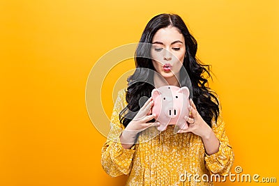 Young woman with a piggy bank Stock Photo