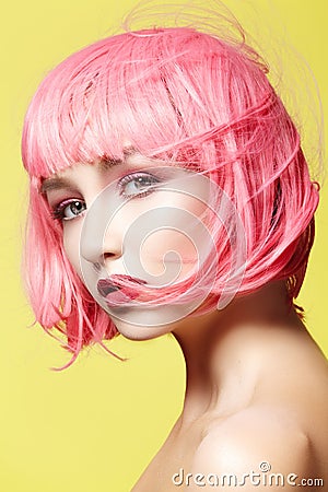 Young woman in pink wig. Beautiful model with fashion makeup. Bright spring look. hair color, medium hairstyle Stock Photo