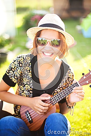 Young woman play on Ukulele. Stock Photo