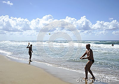 Young woman playing beach tennis on Sabaudia beach. Editorial Stock Photo