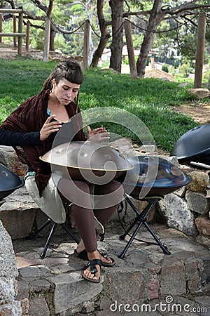 Young woman playing hang instrument Editorial Stock Photo